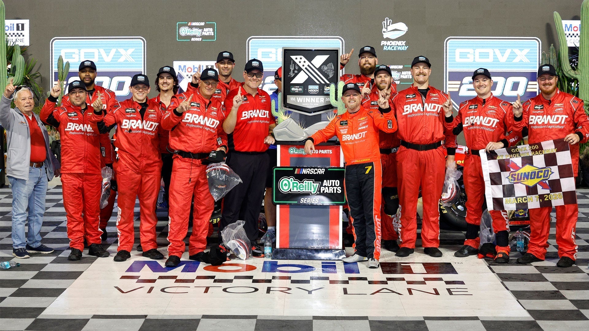 Justin Allgaier and JR Motorsports wearing K1 Custome Race Suits in Victory Lane at Phoenix Raceway