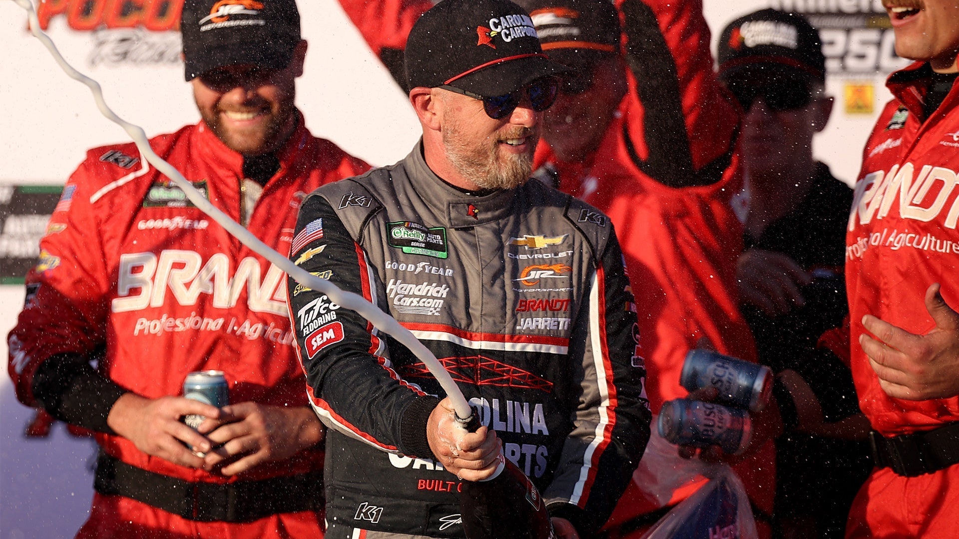 Justin Allgaier sprays champagne after winning the NASCAR O’Reilly Auto Parts Series MillerTech Battery 250 at Pocono Raceway