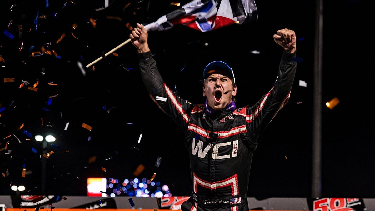 Emerson Axsom wave the checker flag after winning the Shootout