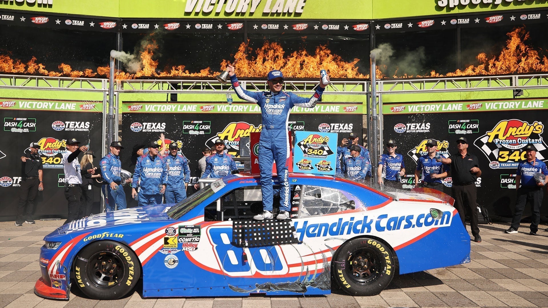 Kyle Larson stands on his car in Victory Lane at O'rielly's Andy’s Frozen Custard 340 at Texas Motor Speedway 